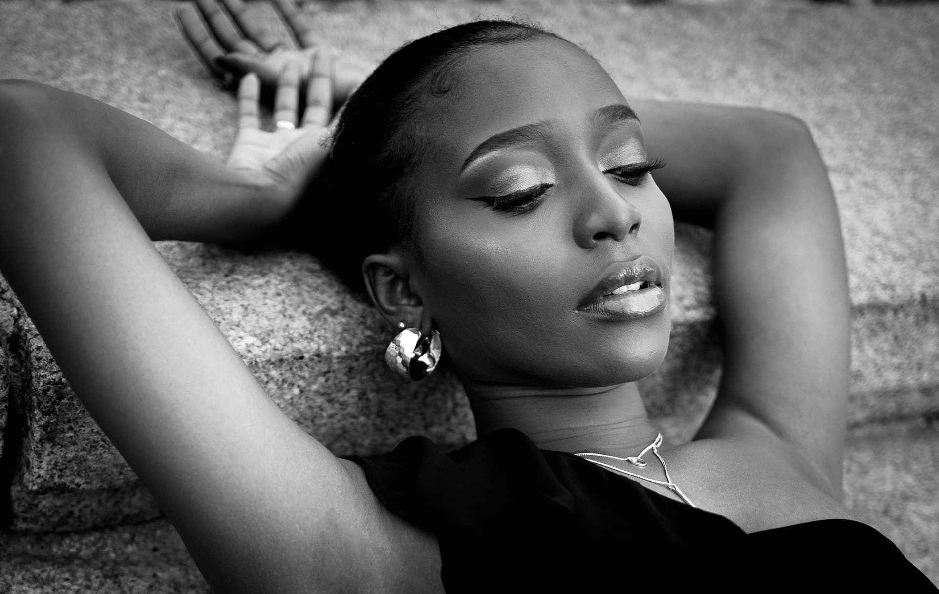 Black and white close-up portrait of Becky Sangolo lying back with eyes closed