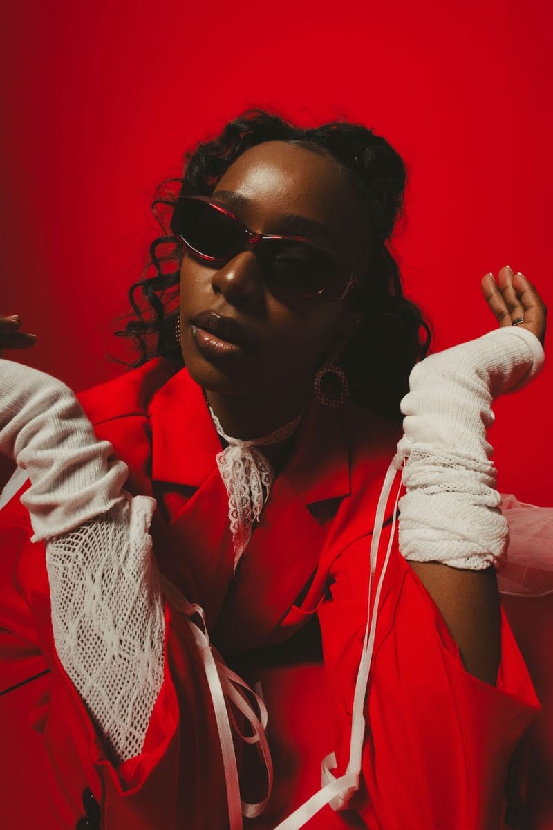 Becky Sangolo in a red-toned studio portrait